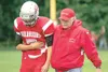 ROBERT DeBERRY/Frontiersman Dr. Dan Larson helps Wasilla senior
Cody Pfeifer off the field during Friday’s game against Juneau at
Wasilla High School.