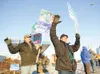 ROBERT DeBERRY/Frontiersman Candidate for Wasilla Mayor Verne
Rupright, center, waves at passing traffic at the corner of the
Parks Highway and Main Street Monday afternoon.