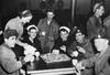 Hostess Betty McHarg, of Los Angeles, Calif., at a United Nations service club in Pusan, Korea on Jan. 26, 1951, supplies hot coffee and donuts to a gathering of soldiers from different lands