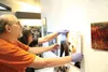 Artists Greg Gusse and Dorothy Page Museum Curator Bethany Buckingham hang a solo show of photographs by Gusse May 20. The show opens with a reception from 5 to 7 p.m., today. HEATHER A. RESZ