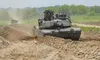 A pair of M1 Abrams tanks from 3rd Infantry Division's 1st Armored Brigade Combat Team roll along a dirt path after breaching an obstacle during an exercise at the Dagmar North Training Area,