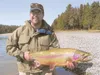 Mike Coughlin holds a monster rainbow trout he caught during
spring fishing on the Kenai River.