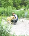 Larry Eaker slips a collar around the neck of a dog that will
head to Eaker's Wasilla-area home. The Eakers kept seven dogs, but
turned over 15 to the Mat-Su Borough last week. Photo by RINDI