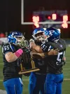 Palmer linemen Chandler Coman, Aiden Don and Luke Sena celebrate with the Mayor's Cup after a 54-19 win in the 2024 Potato Bowl. J. David McChesney/Frontiersman