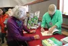 Chad Carpenter signs a copy of the 30th anniversary edition of Tundra Comics at the Palmer Train Depot. Jacob Mann/Frontiersman