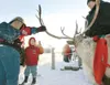 Janette Goss shows her grandson Fisher Crum, 5, the antlers of a
reindeer Saturday during a past Colony Christmas celebration in
Palmer. (ROBERT DeBERRY/Frontiersman)