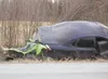 A Kawasaki all terrain vehicle sits against the rear bumper of a
four-door sedan in the ditch off Tait Drive Saturday afternoon.
(ROBERT DeBERRY/Frontiersman)