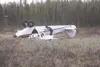 An Alaska State Trooper takes a photograph of a Piper PA-12 Bush
plane that lost power around 3:15 p.m., Tuesday afternoon and
crashed in a marsh off Caribou and Charley streets. (K.T.
McKEE/