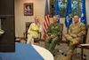 U.S. Air Force Gen. Ken Wilsbach, Pacific Air Forces (PACAF) commander, center, Chief Master Sgt. David Wolfe, PACAF Command Chief, and Cindy Wilsbach, spouse of Gen. Ken Wilsbach, share key 