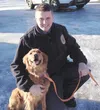 Trooper Lucas Hegg poses with Amber, the golden retriever credited with saving her owner’s life March 2. Courtesy Alaska State Troopers