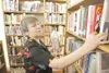 ROBERT DeBERRY/Frontiersman Library aid Susan Kammermeyer
returns books to the shelf Monday at the Wasilla Public
Library.