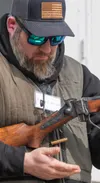 Livi McKinley ejects a 45-70 case from Gordon Romriell's Shiloh Sharp rifle, provided by Mike Barnett, after securing second place in his shoot off against Bob Boyle at the Tug Bar 41st annua