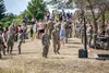 U.S. Army Lt. Col. David Roman, commander, and Command. Sgt. Maj Robert Christensen, 1st Battalion, 3rd Aviation Regiment (Attack Reconnaissance), stands among a crowd of Soldiers and family 