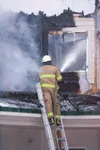 Water is sprayed on the upper floor of a home on Hart Lake Loop
Friday afternoon. Crews from Central Mat-Su and Palmer fire
department responded to the two-story blaze. (ROBERT
DeBERRY/Fronti