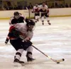 Rick Morlock skates the puck into the zone for the Hawks during
Houston's 6-2 loss to West High School Friday. Photo by JEREMIAH
BARTZ/ Frontiersman.
