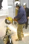 State Sen. Charlie Huggins takes part in the Rebar Cutting
Celebration Friday at Houston High’s new welding lab housed at
Houston Middle School. Welding teacher Scott Ruta stands by in the
ba