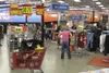 Shoppers comb through racks of clothes at the Wasilla Sports Authority on Friday, July 15. The store will close for good Sunday, the end of a two-month liquidation process that came on the he