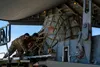 Airmen assigned to the 732d Air Mobility Squadron load cargo onto a C-17 Globemaster III assigned to Joint Base Lewis-McChord, Washington, on the flightline at Joint Base Elmendorf-Richardson