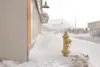 ROBERT DeBERRY/Frontiersman Snow drifts block access to the the
sidewalk and store fronts along West Evergreen Avenue in downtown
Palmer during Monday's wind storm