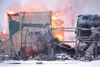 ROBERT DeBERRY/Frontiersman A building destroyed by an explosion
burns at the Fairbanks Natural Gas facility on Ayshire Road early
Thursday morning.