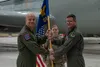 U.S. Air Force Col. Derek Rachel, 55th Operations Group commander, Offutt Air Force Base, Neb., passes the guidon to Lt. Col. Kelsey Bryant during the 55th OG Detachment 1 assumption-of-comma