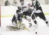 ROBERT DeBERRY/Frontiersman Colony sophomore Forrest Savel
blocks a Houston shot as Colony blueliner Stephen Tobin moves
Houston'€™s Ken Doss out of the crease Friday at the Curtis C.
Menard 
