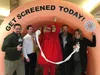 Hospital CEO, Dave Wallace, dressed as Wollop the Polyp poses with Mat-Su Regional Medical Center leadership under a seven-foot tall colon during March’s Colorectal Cancer Awareness Month in 