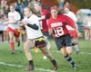 ROBERT DeBERRY/Frontiersman Leisl Brown moves the ball down the
field for a first down during the powder puff game Thursday at
Wasilla High School.
