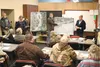 Mat-Su Borough Assembly member Jim Sykes, left, standing, borough permit technician Michelle Olsen, Emergency Manager Casey Cook, and Boutet Company, Inc., planner Jim Jager address Butte res