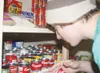 TODD L. DISHER/Frontiersman Colony High School student Chris
Kast helps stock a shelf of canned soup at the Wasilla Food
Pantry.