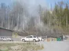 VIRGINIA FILIKINS/Frontiersman Smoke rises from a black swath of
burned grass left by a fire that threatened some Wasilla area homes
Monday.