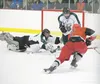 Wasilla defenseman Andrew Cooley moves the puck in on goal as Colony’s Curtis Foster and goaltender Colton Beebe block the shot during the Warriors’ 6-0 win over Colony Friday at the Brett Me