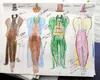 Sketches for the munchkin costumes, including the Mayor of Munchkinland’s outfit, sit on a table at Roxann Benbow's house. The mayor's costume is being offered as a McCall's pattern. ROBERT D