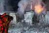 A firefighter wipes sweat from his brow after changing out his oxygen tank while fighting a fire on Sunday, Nov. 15, 2015 near Big Lake. No one was injured in the blaze, which destroyed a sin