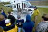 Above top, pilot Wiley Simon, and helicopter foreman Norm
McDonald talk to a firefighter class Thursday afternoon at the
Mat-Su helibase.