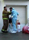 Two emergency responders place gloves, masks and outer garments
into plastic bags after examining a suspicious package found
Wednesday at the new Wasilla Sears store. Photo by NAOMI
KLOUDA/Fr