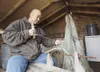 Sgt. Burt Paul, an infantryman with the 297th Infantry Regiment, mends a fishing net at his home in Kipnuk Sept. 21. Subsistence hunting is a way of life for Paul and other Alaska Natives in 