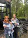Talkeetna firefighter Andrew VanOrnum and his family stand outside the charred remains of their home. Courtesy photo.
