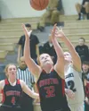 Houston's Emily Bitler battles with Nikiski's Kaycee Bostic for the rebound as Houston's Denali Whitted watches Friday, Feb. 21, 2020, at Nikiski High School in Nikiski, Alaska. Photo by Jeff