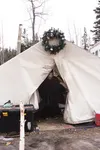 Josh DeGraw peeks out from inside a 10-feet-by-14-feet canvas tent. Josh, and the rest of the DeGraws, plus three dogs have lived in the tent since July 1, and recently secured permanent hous