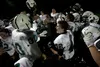 The Colony Knights varsity football team crowds around head coach Brian McIntosh after defeating the Palmer Moose Friday at Machetanz Field in Palmer. ROBERT DeBERRY/Frontiersman.com