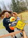 Pamela Speer (right) and Janie Herrera (left) pose with Mr. Vanderquack at the Iditarod Headquarters. Courtesy photo