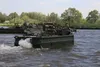 U.S. Soldiers with the 1st Battalion, 66th Armor Regiment, 3rd Armored Brigade Combat Team, 4th Infantry Division, get a tank across the river on the ribbon bridge during a wet gap crossing d
