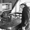 Eric Young demonstrates a machine that bends steel concrete
reinforcement bar at J.D. Steel's Palmer fabrication yard. The
bending bench has a rotating turntable that wraps the rebar around
t