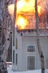 Flames shoot from the roof of a home on Hart lake Loop Friday
afternoon. Crews from Central Mat-Su and Palmer fire department
responded to the two story blaze. (ROBERT DeBERRY/Frontiersman) R