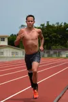 Jamie Brown, U.S. Paratriathlon National Team elite paralympic athlete, runs on the track Aug 12, 2019, on Kadena Air Base, Japan. Brown prepares for the Tokyo 2020 Paralympic Games by sticki