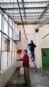Instructor Don Berberich works with sophomore Chris Echternaht to sanitize the Palmer High School greenhouse. Photo Courtesy Don Berberich