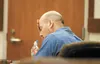 Phillip Bailey sits with his head on his hand as opening statements start in his trial Thursday afternoon in Palmer. Bailey is accused of killing Dale Prater in October 2011. ROBERT DeBERRY/F