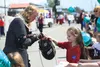 A young girl tests the weight of a helmet belonging to a member of the Society for Creative Anachronism during the Fourth of July Parade in Wasilla Friday. The group won second place in the G