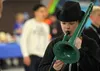 Sixth-grade Teeland Middle School student Justin Singleton tests out a green trombone from Alaska Music and Sound on Saturday at the statewide Valley Jazz Festival held at Palmer High School 